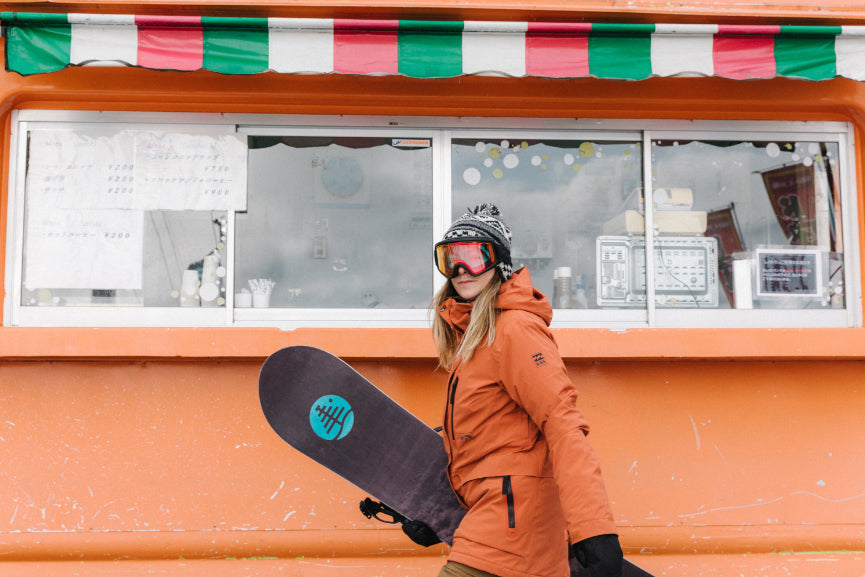 Snowboarder infront of a Crepe truck in Japan