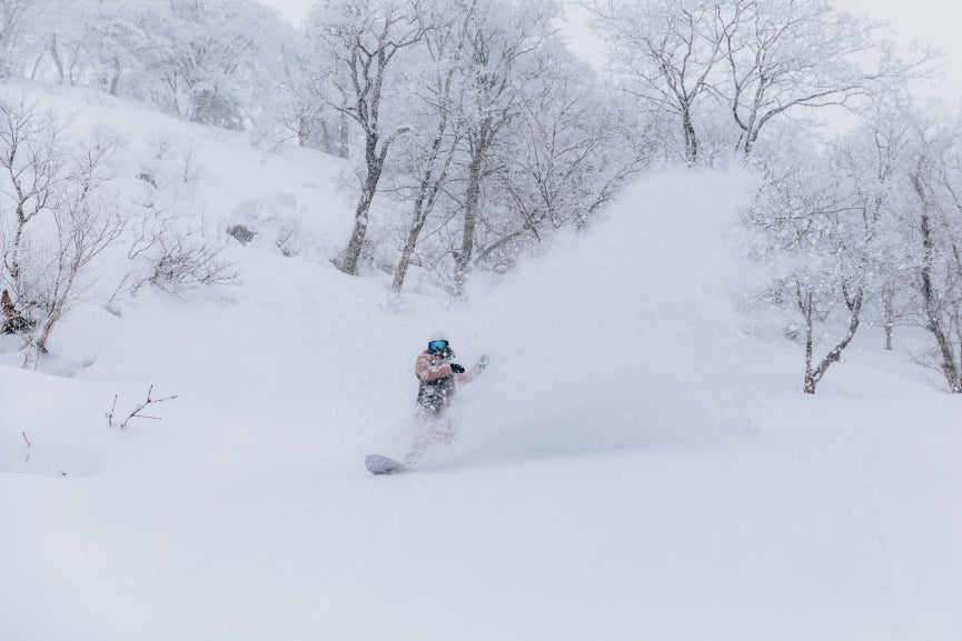 Snowboarder riding in Japan