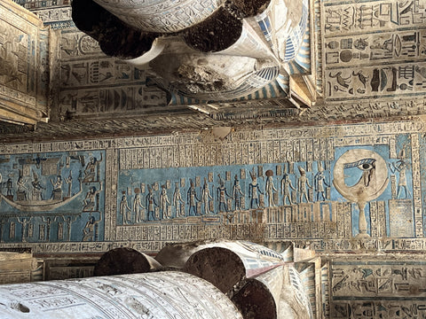 Hathor temple pillars and colorful eye of hour on the ceiling at the dendera temple of Hathor