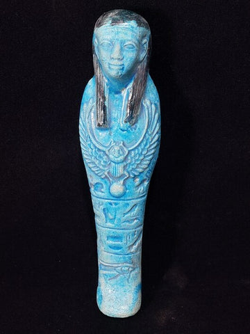 Vintage blue ushabti statue with a scarab and eye symbol on the front