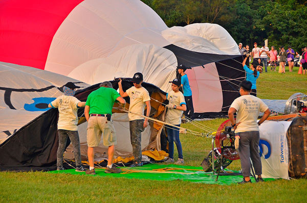 A crew helps inflate a hot air balloon with the assistance of a Ventry Fan