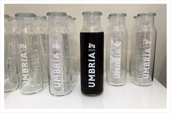 Caffe Umbria logo glass water bottle, empty or filled with cold brew coffee