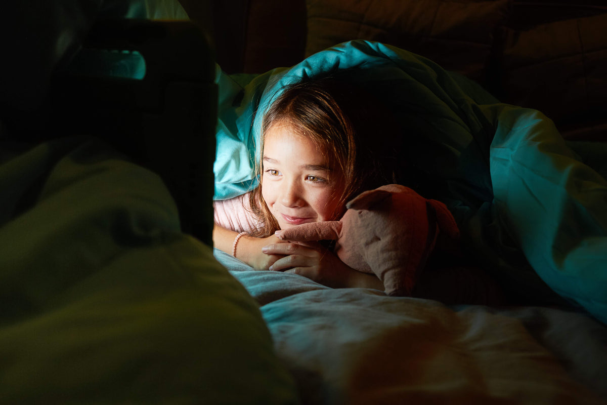 Girl watching her iPad in the dark