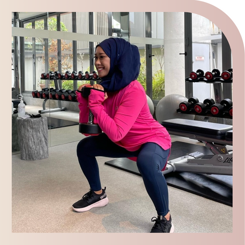 A customer exercising while wearing a pink Spark Half-Zip by Veil Garments, a modest activewear sweatshirt.