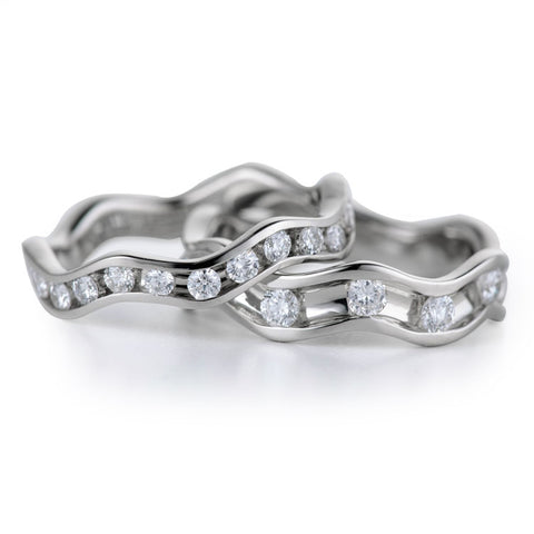 Rings for active women round diamonds flowing in an 18k white gold channel in Davidson Jewels designed bands