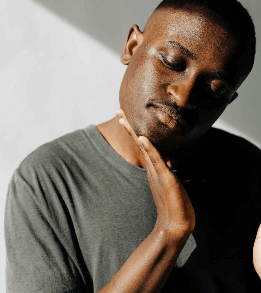 Man wiping off the Supply face scrub using his palm