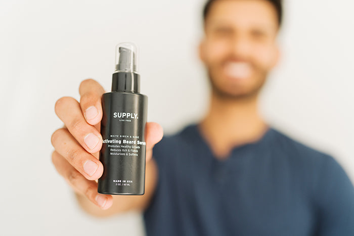 Man holding beard growth serum