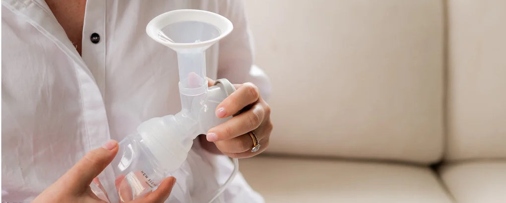 woman holding a breastpump