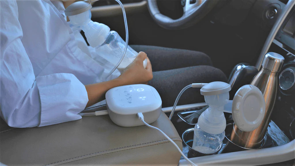 mother using breast pump in the car