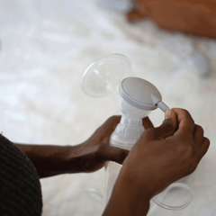 woman holding single breast pump