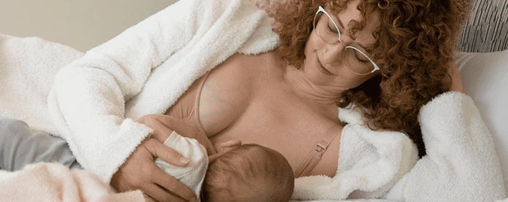 woman breastfeeding baby and wearing maternity bra