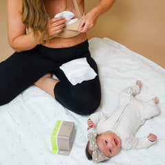 woman using nursing pads with baby
