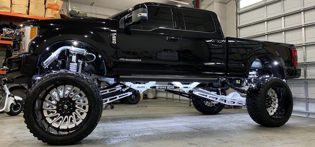 F250 lifted truck 16 to 20 inch custom black and white Stryker 4-link Lift