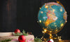 Globe covered in holiday lights to represent Christmas Around The World 