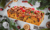 A perfect fruitcake with a holiday background.