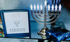 A Menorah and sign wishing A Happy Hanukkah