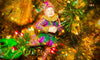Ornament of a Jester in Mardi Gras colors on a Christmas Tree on display for the holiday season in New Orleans