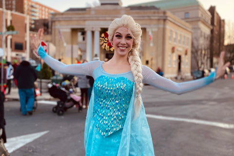 Elsa from Frozen posing at a holiday display