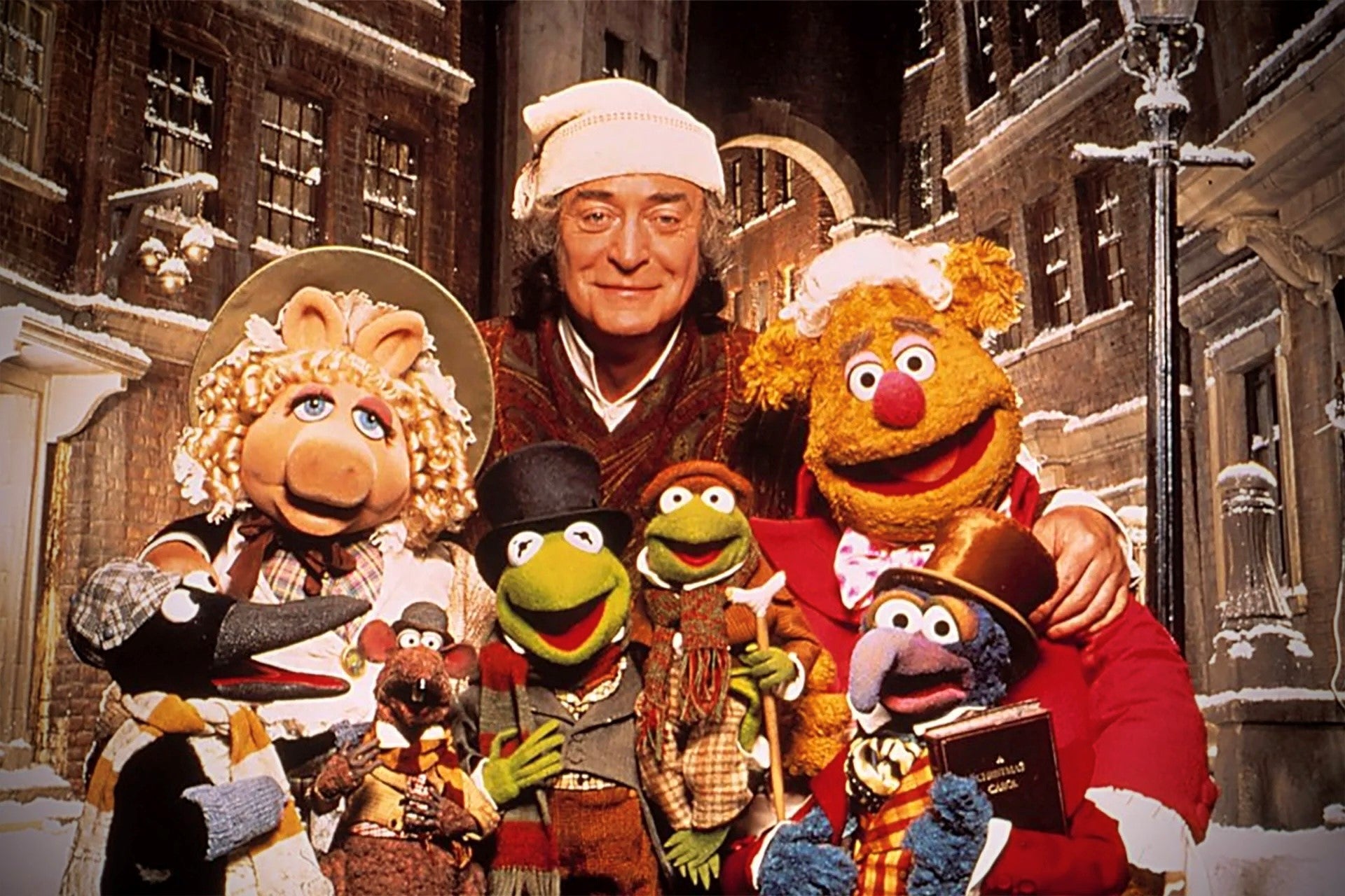 Michael Caine as Scrooge, surrounded by a cast of Muppets in The Muppet Christmas Carol