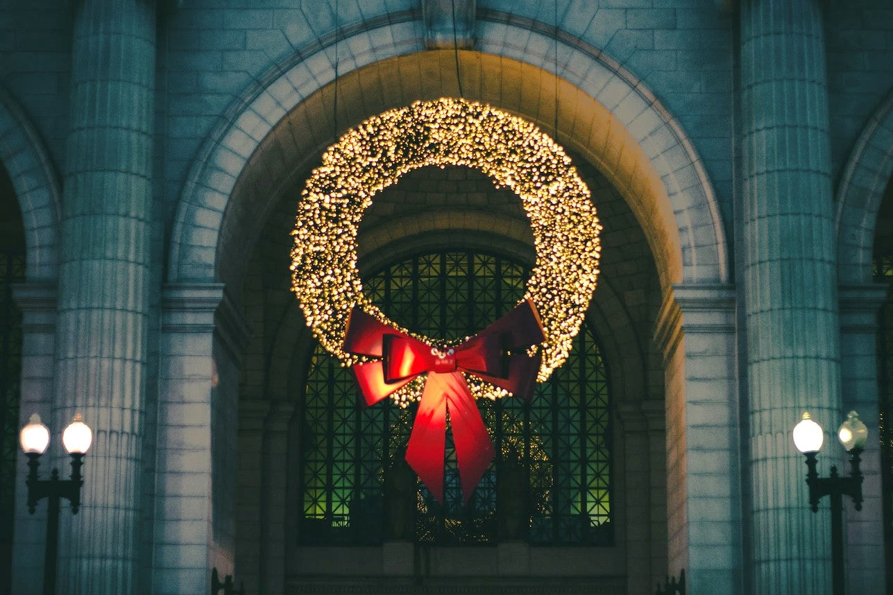 Oversized commercial Christmas wreath on a NYC business with led lights and a big bow