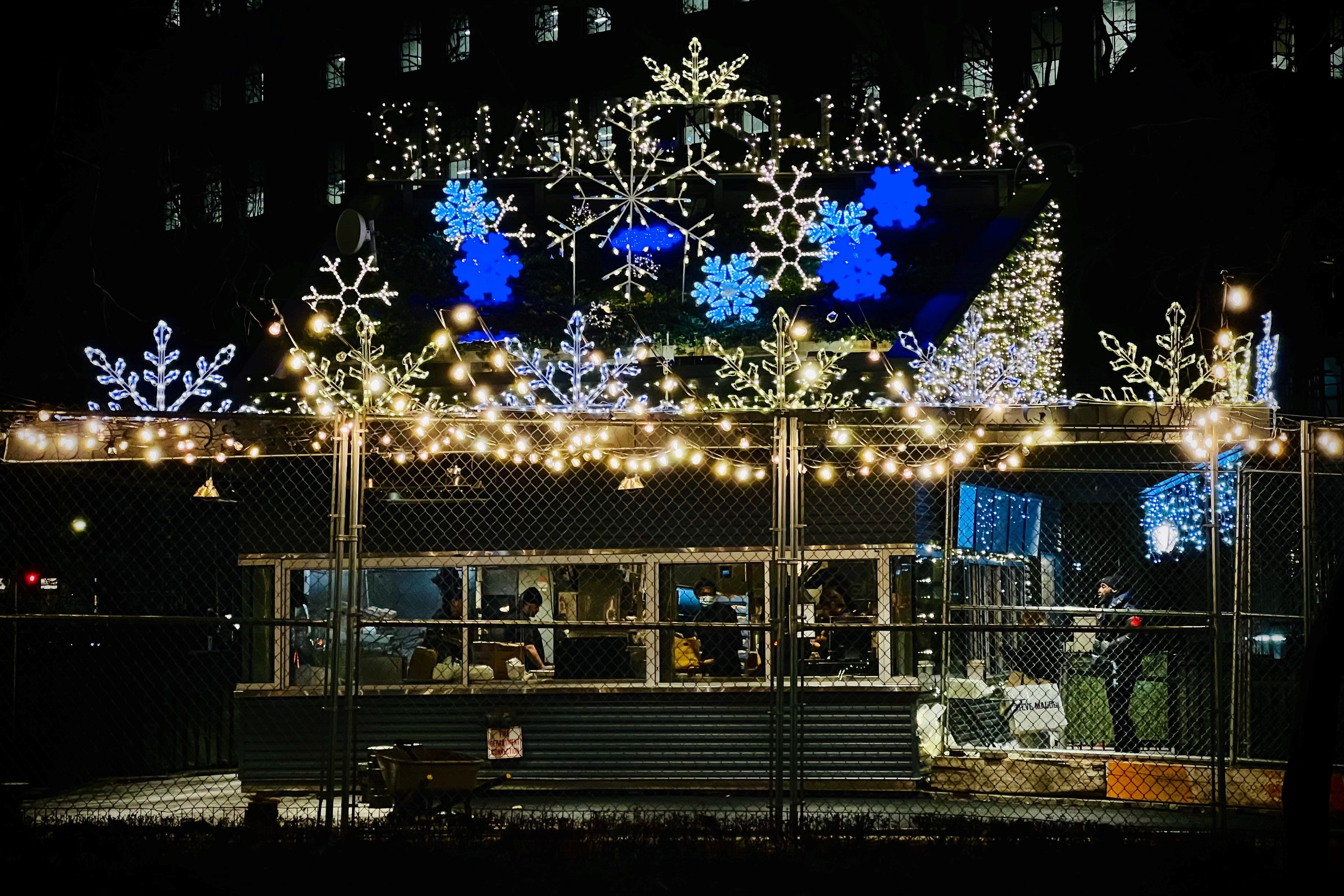 Shake Shack in Madison Square Park decorated for Christmas with Oversized Snowflakes on the roof - NYC