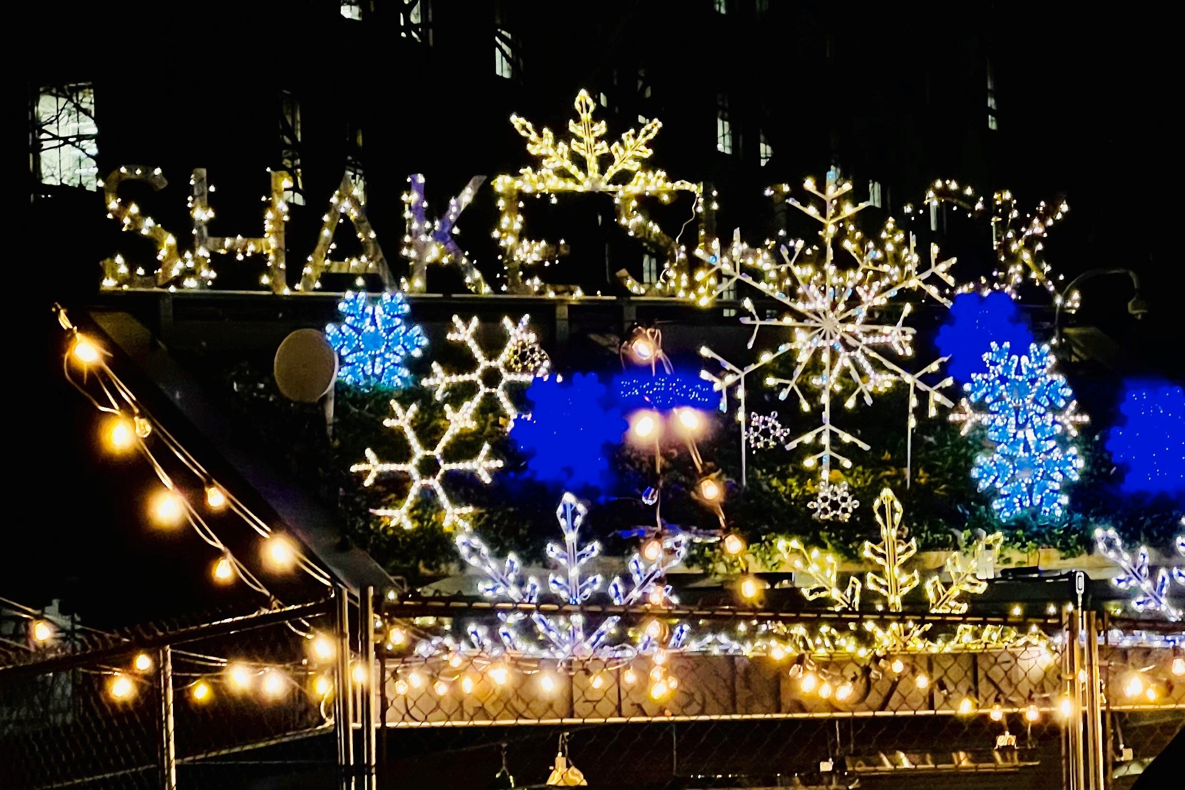 Shake Shack NYC Madison Square Park location decoration with Christmas lights, icicle lights and oversized snowflakes in warm white, cool white and blue