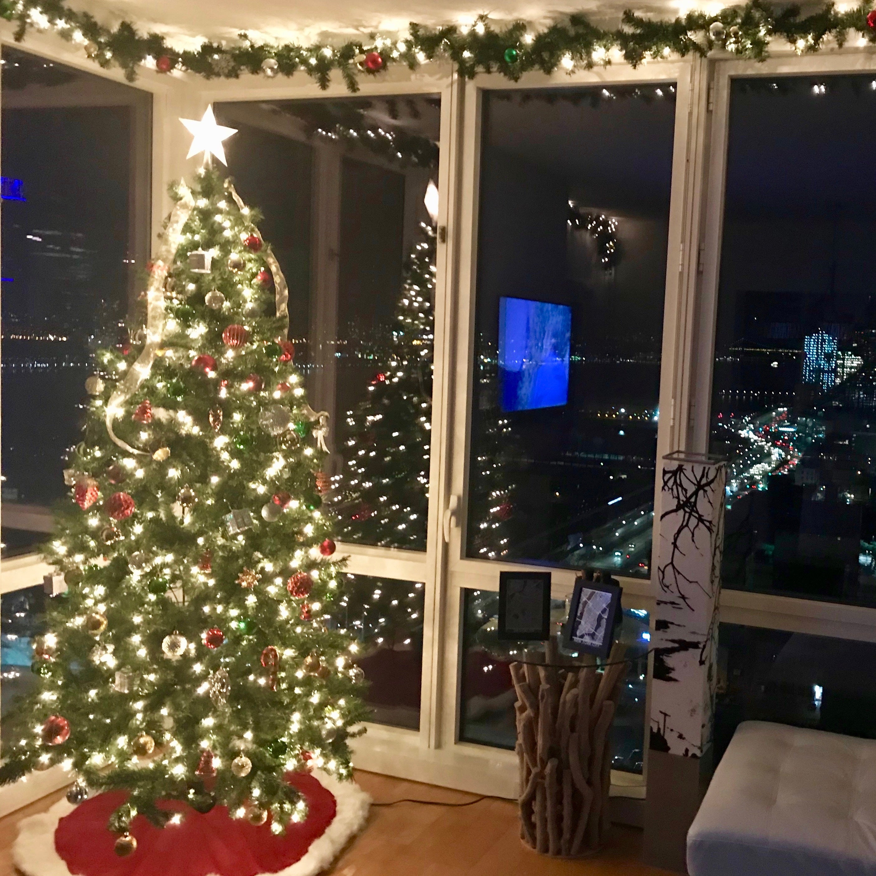 Decorated artificial Christmas tree and garland in residential living room