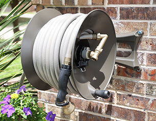 How to mount a wall mount hose reel to a house