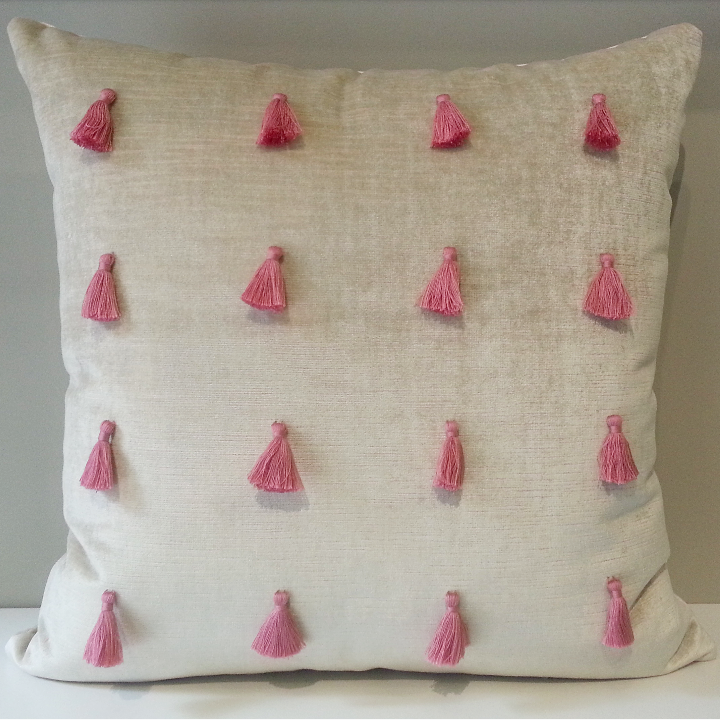 pink pillow with tassels