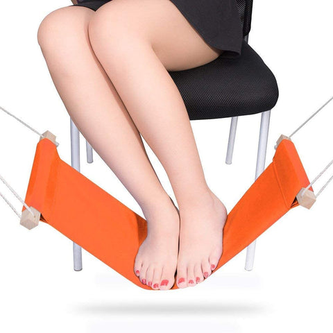 foot rest, foot hammock, orange foot hammock, lady sitting on a chair, lady resting her feet, white chair, black dress