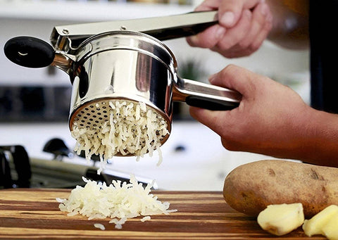potato ricer, potato masher, mashed potato, hands, stainless steel potato ricer, grated potato, potatoes, kitchen