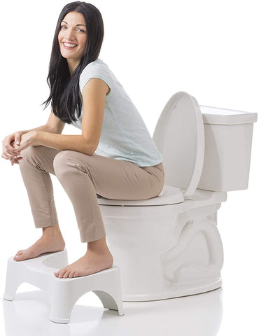 Lady sitting on a toilet, squat stool