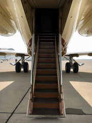 (plane on the ground with the stairs) Ventral stairs on the Getty family's private 727 (aka the "Jetty")