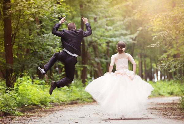 Happy wedding couple in West Coast green surroundings