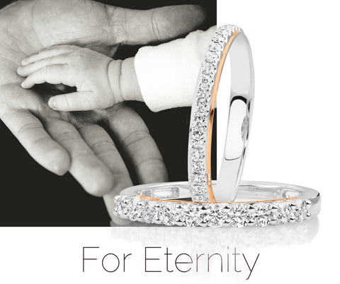 Eternity ring image with baby hand in palm of parent