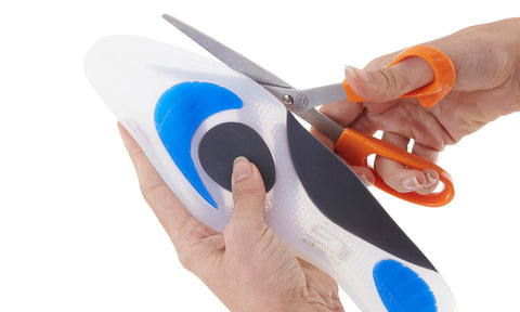 Scissors cutting along cut points of Neo G NeoThotics Silicone Full Length Insoles