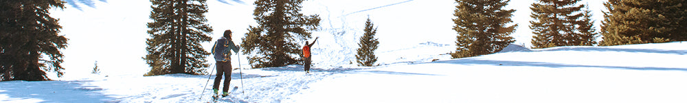 People in ski equipment walking in snowy area