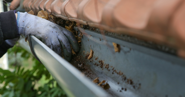 remove debris to unclog downspout