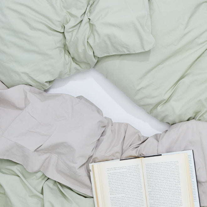 Overhead of sage and grey percale bedding