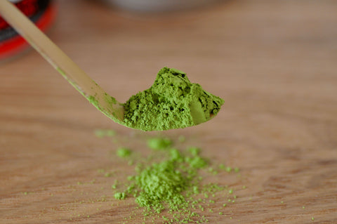 Matcha green tea fine powder sitting on a chasaku