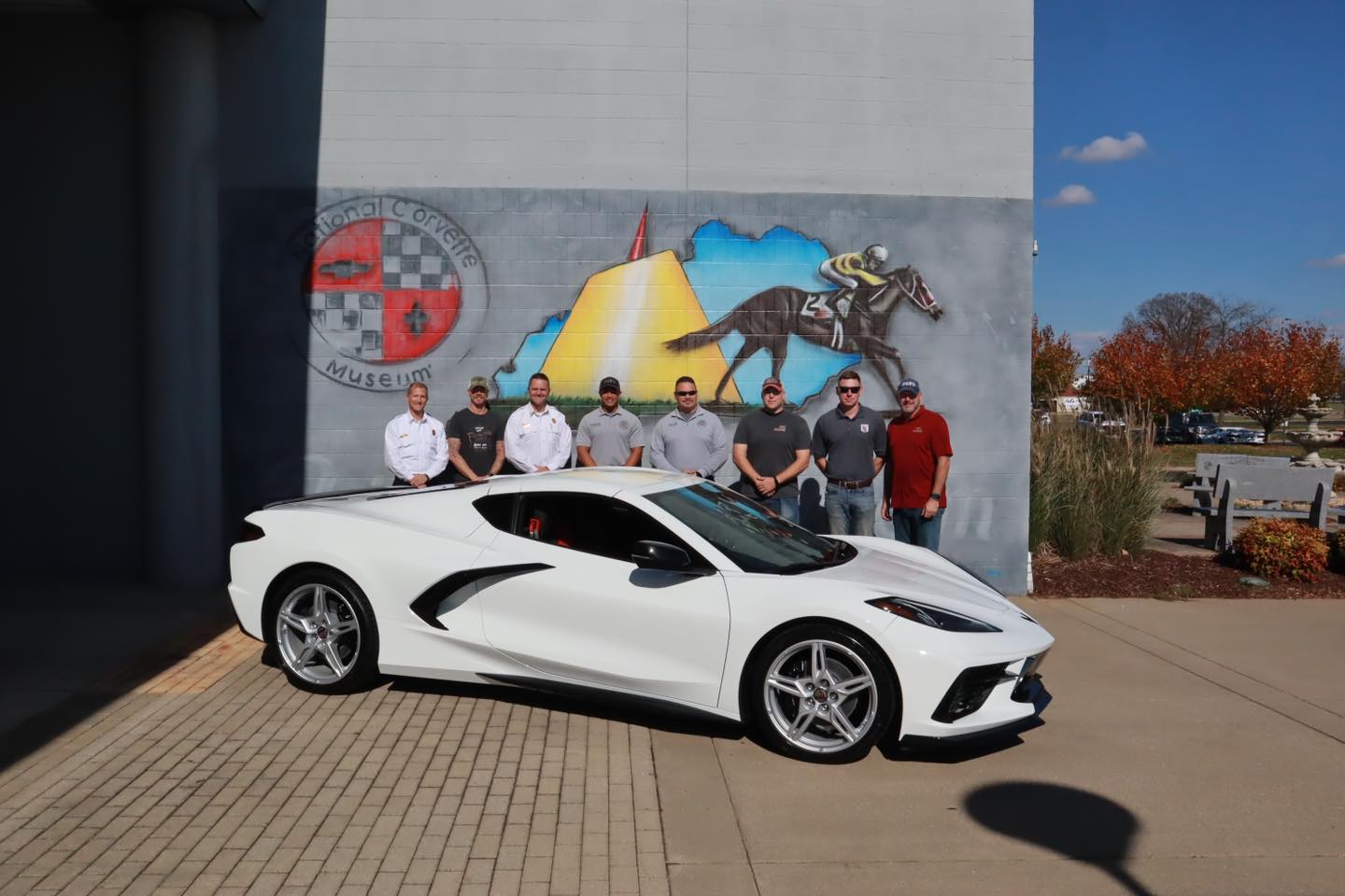 Bowling Green Fire Department behind their Corvette infront of the Nation Corvette Museum