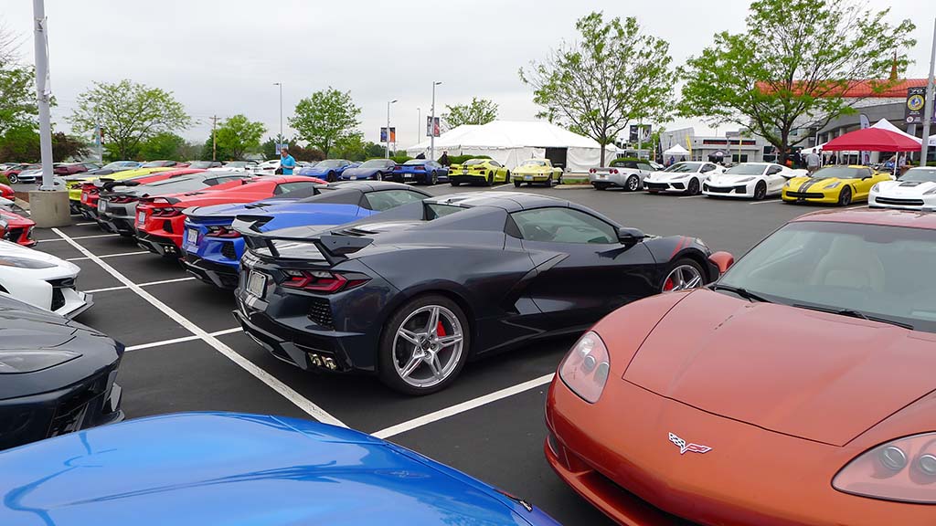 A lineup of C8 Corvettes in shadow grey metallic, riptide blue, velocity yellow, torch red, and daytona sunsrise orange