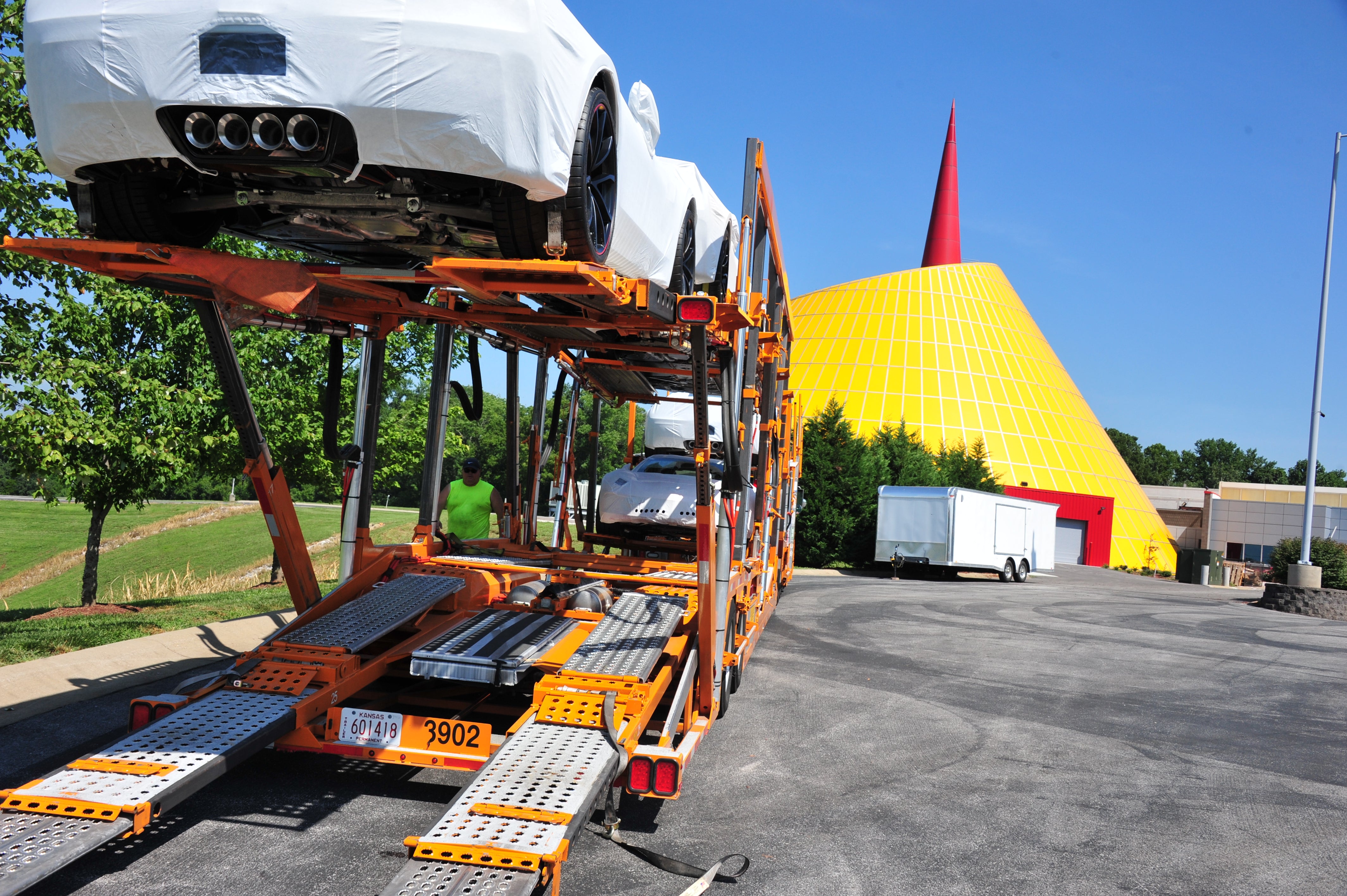 Corvettes on a transport outside the National Corvette Museum