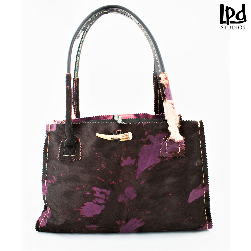 Overdyed Purple Plum Brindle Fur Leather Tote with Tassels - LPDstudios was created by designer artist Lisa Parmer Ditty. All of her designs are handcrafted in her Pennsylvania studio. She has merged her love of leather, metal and metal clay to create a unique collection of custom leather handbags, metal and leather jewelry and even pet collars. Follow her studio blog and see what she is designing next.