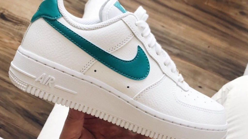 clean white nike shoes with teal swoosh
