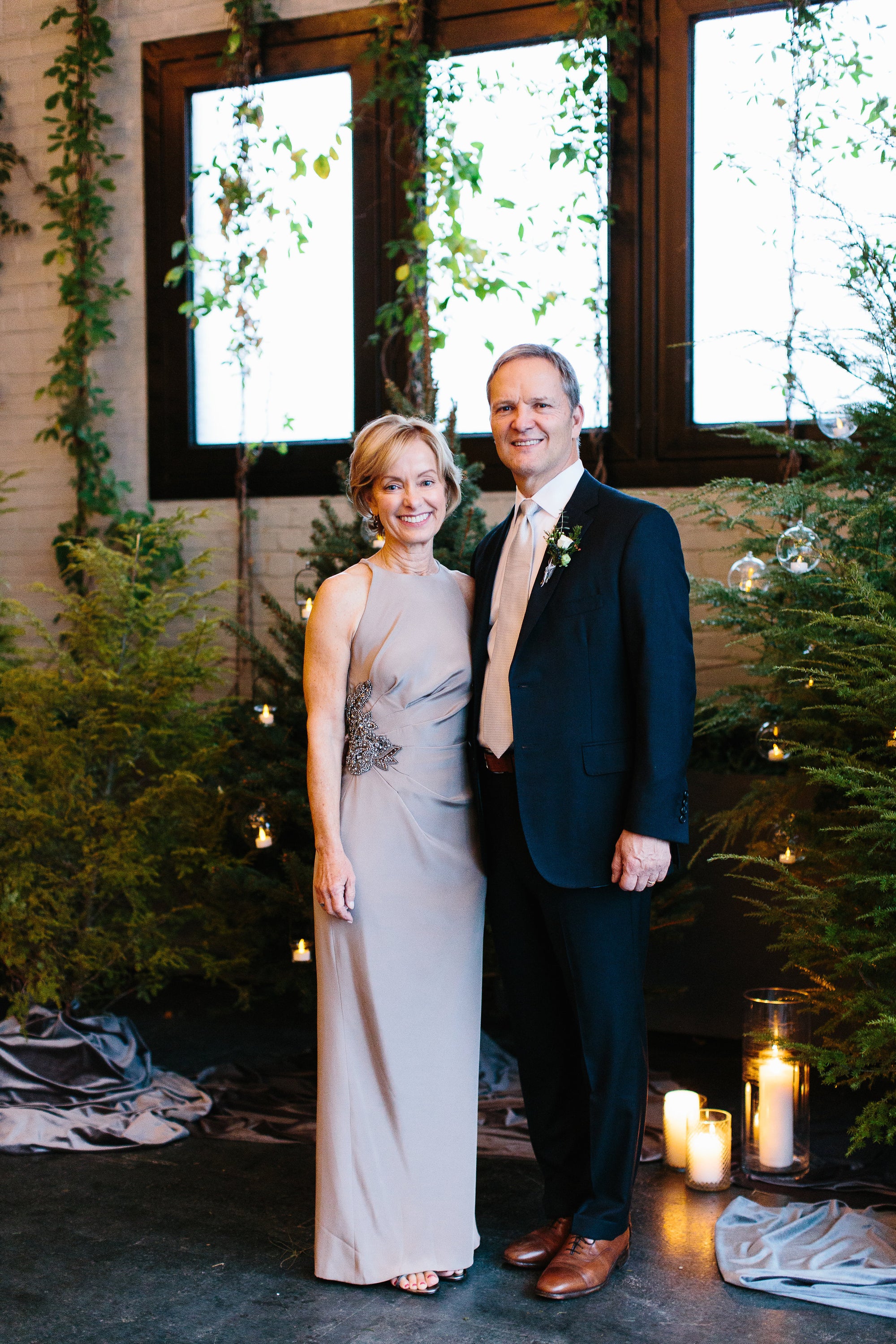 Pam Lamp wearing a custom designed taupe mother of the bride gown cinched at the side at her son's wedding in Brooklyn, New York.