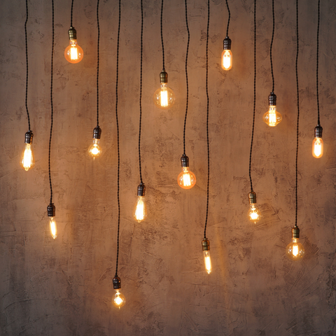 several edison light bulbs hanging on cords in various shapes, sizes and lengths - all LED