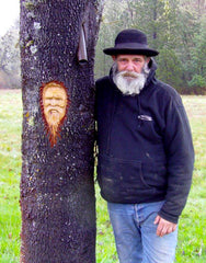 A dear friend mushroom harvester beside his image carved into a tree by a fellow forager friend.