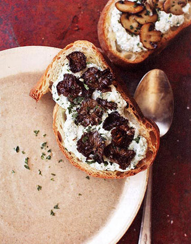 Bowl of Classic Meadow Mushroom Soup with Wild Mushroom and Herbed Ricotta Tartines made with Wine Forest Wild Foods premium dried wild porcini mushrooms. Photo by Sara Remington courtesy Viking Studio, The Wild Table