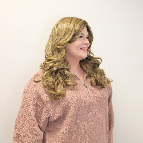 Curly medium length style in a medium brown color with medium blonde highlights